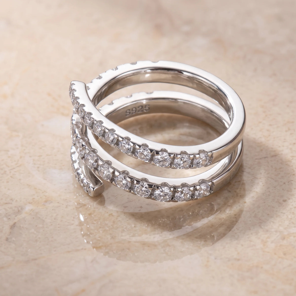 Close-up of the moissanite triple wrap spiral ring in 925 sterling silver with a white gold finish showing the S925 hallmark stamped inside the band - Sensitive Stones