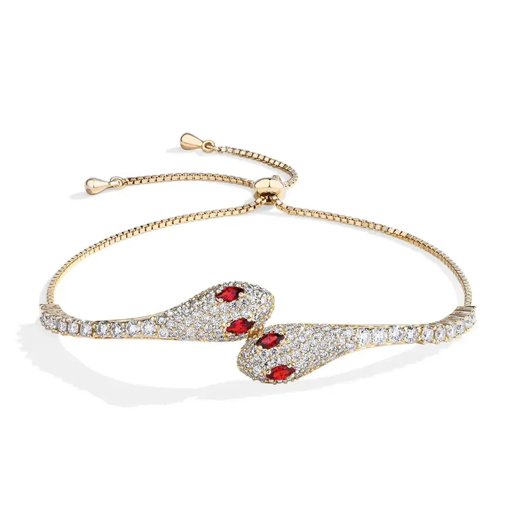 Moissanite twin snake bracelet in 925 sterling silver with a yellow gold finish showing two pave serpent heads with red cubic zirconia eyes - Sensitive Stones