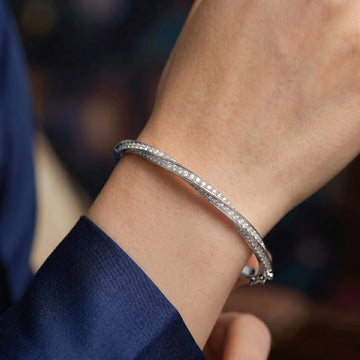 White gold moissanite twist bangle bracelet worn on wrist, 2mm stones in 925 sterling silver - Sensitive Stones