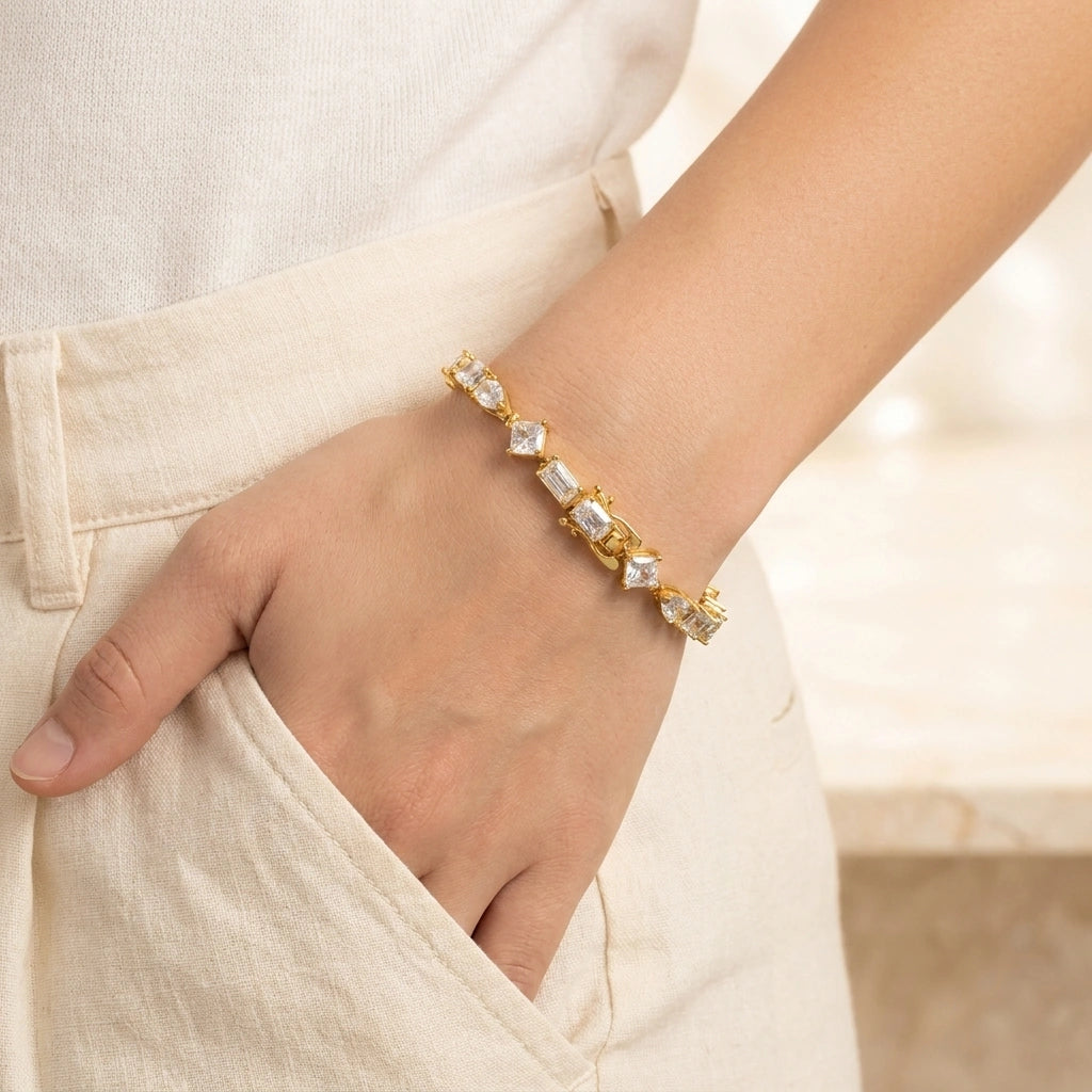 Woman wearing the multi shape moissanite tennis bracelet in yellow gold - Sensitive Stones