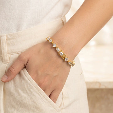 Woman wearing the multi shape moissanite tennis bracelet in yellow gold - Sensitive Stones