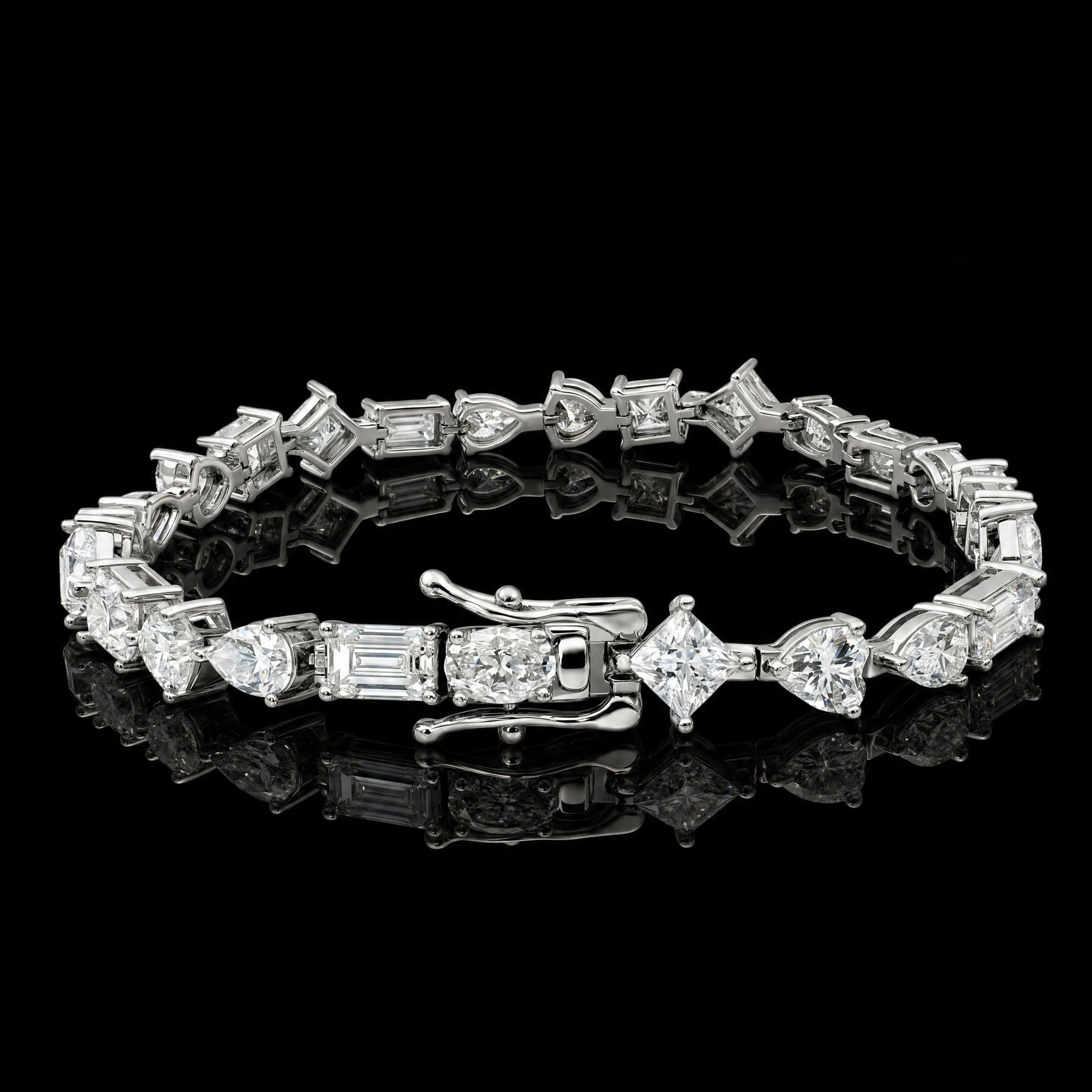 A multi shape moissanite tennis bracelet with clear pear, oval, heart, princess and emerald cut stones in 925 sterling silver with a white gold finish, on a reflective black background - Sensitive Stones
