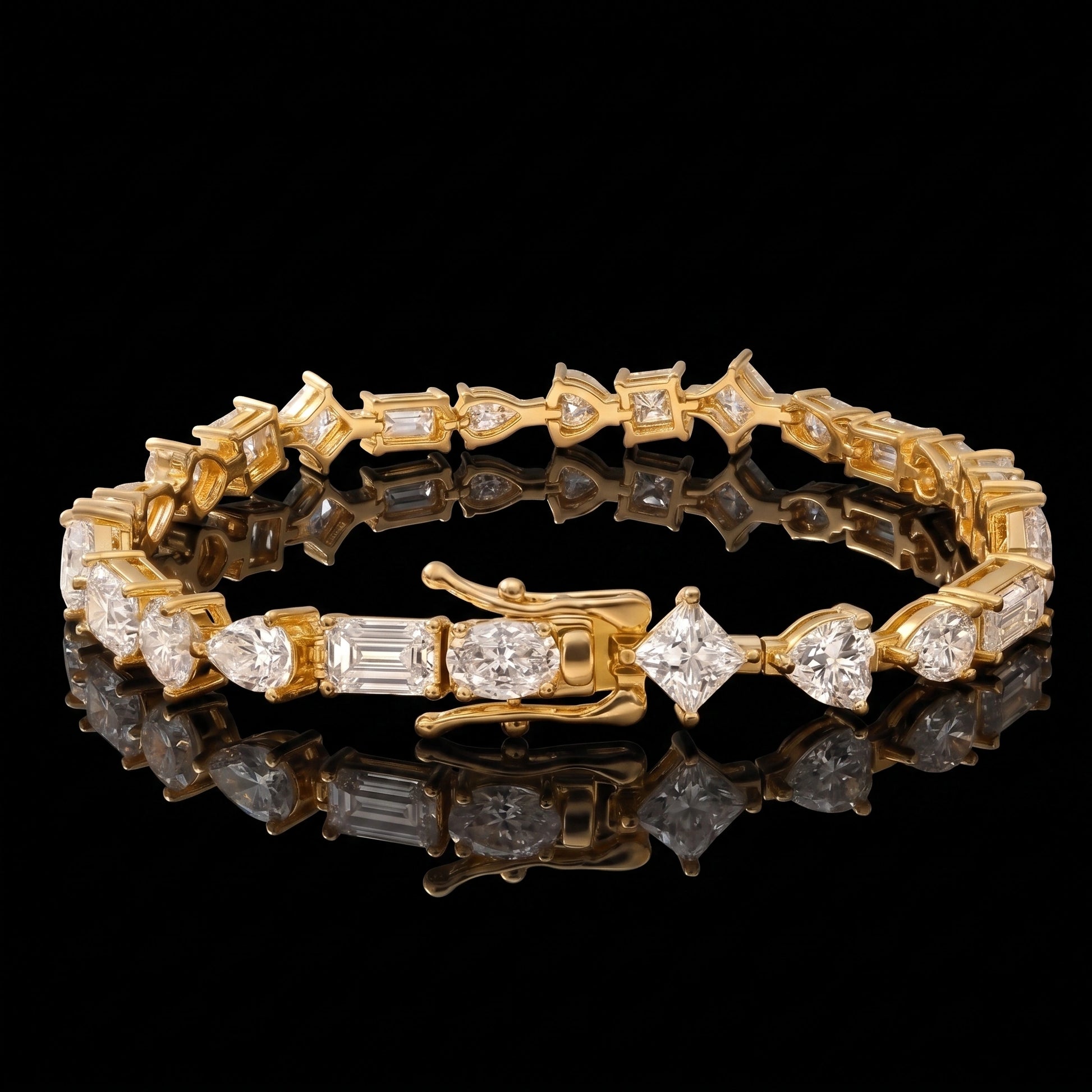 A multi shape moissanite tennis bracelet with clear pear, oval, heart, princess and emerald cut stones in 925 sterling silver with an 18K yellow gold finish, on a reflective black background - Sensitive Stones