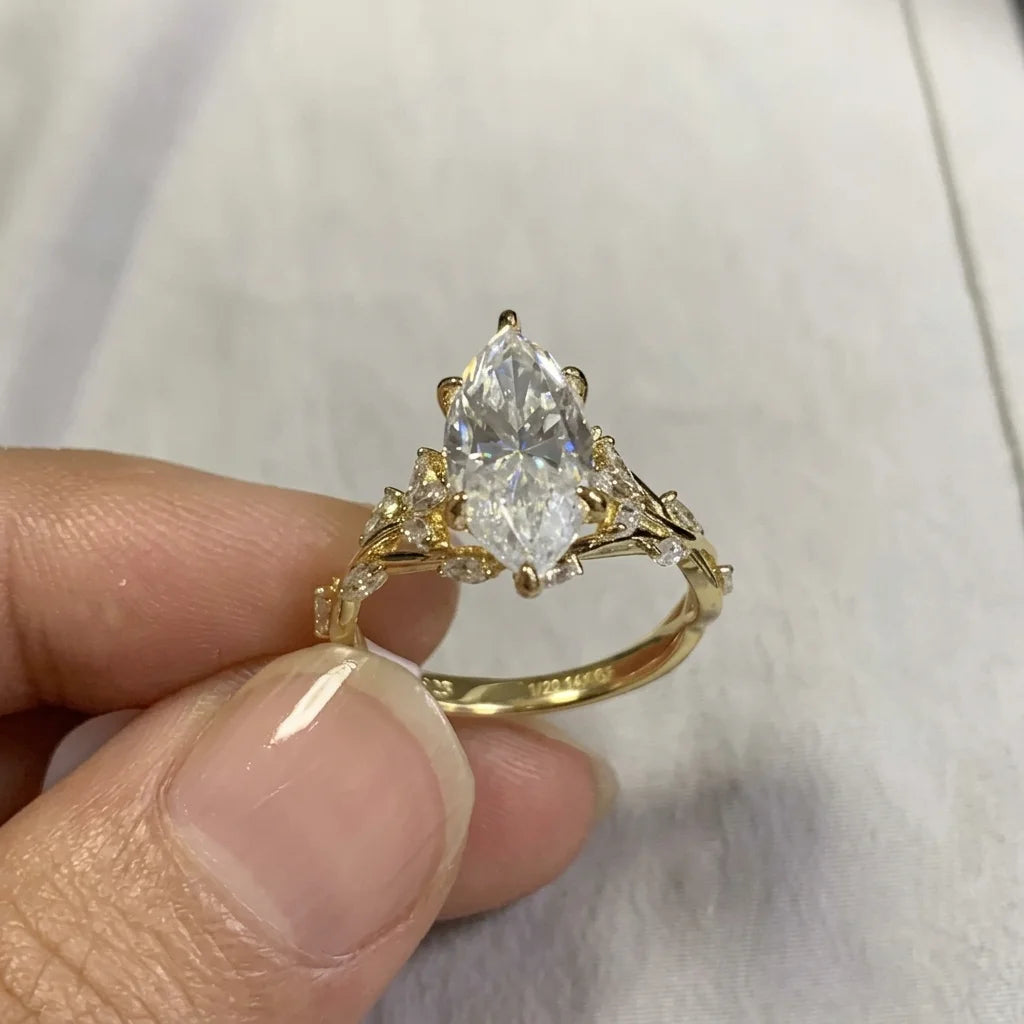 3ct marquise moissanite ring in 14K gold filled styled with daisies, top view of the vine band - Sensitive Stones