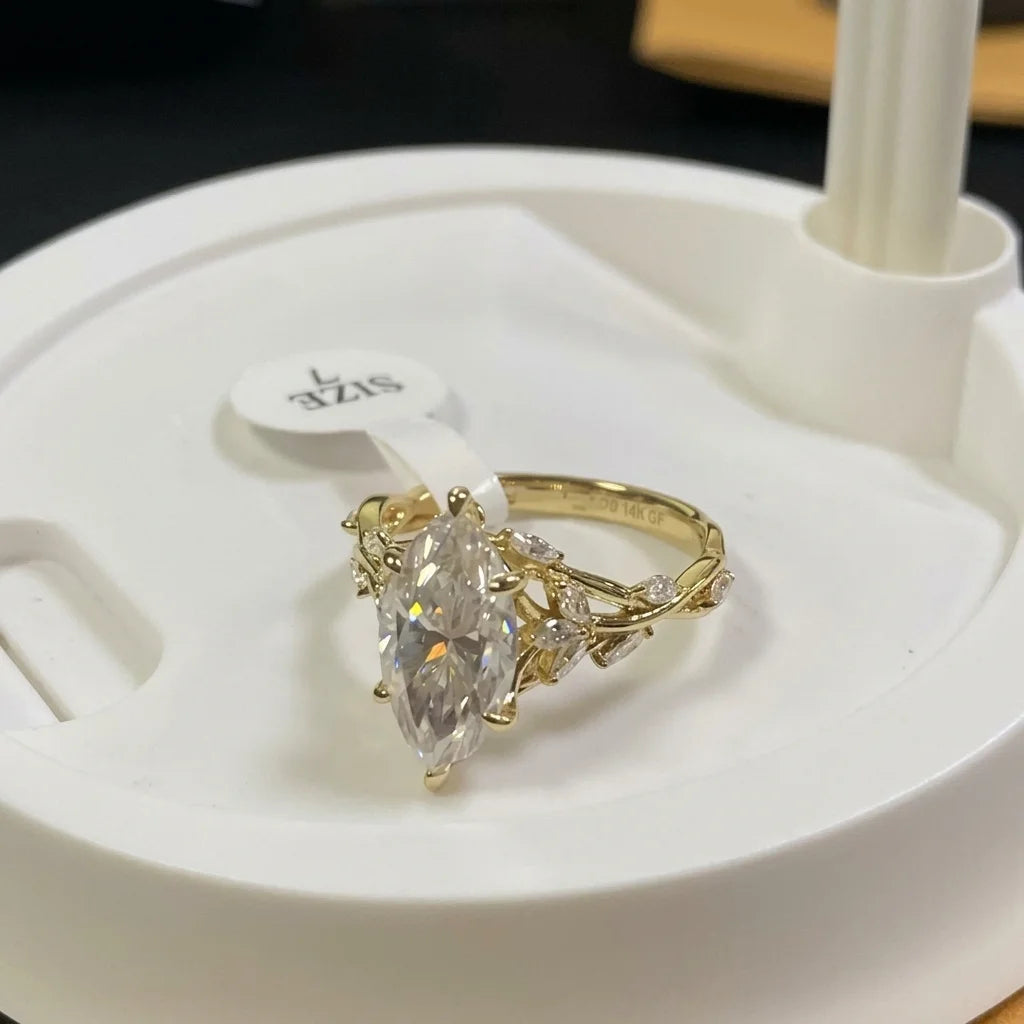 Three-quarter view of the twisted vine band and leaf-set accents on the 14K gold filled marquise moissanite ring - Sensitive Stones