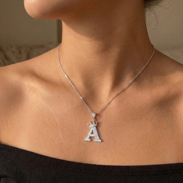 Moissanite crown initial necklace letter A worn at collarbone black off-shoulder top - Sensitive Stones