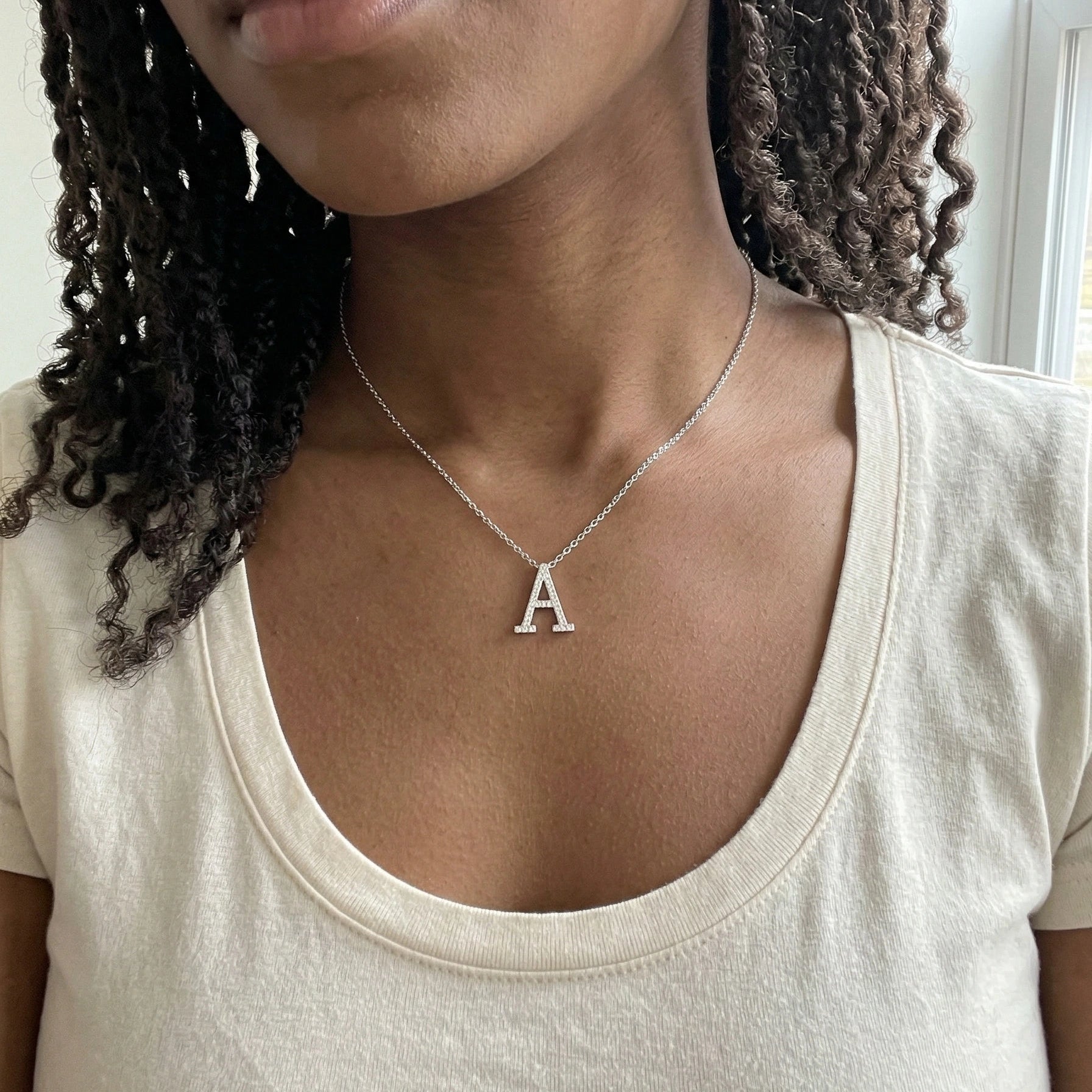 Moissanite initial necklace letter A worn by Black model cream scoop neck top - Sensitive Stones