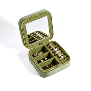 Olive green velvet travel jewelry box open showing ring rolls and earring compartments with built-in mirror - Sensitive Stones