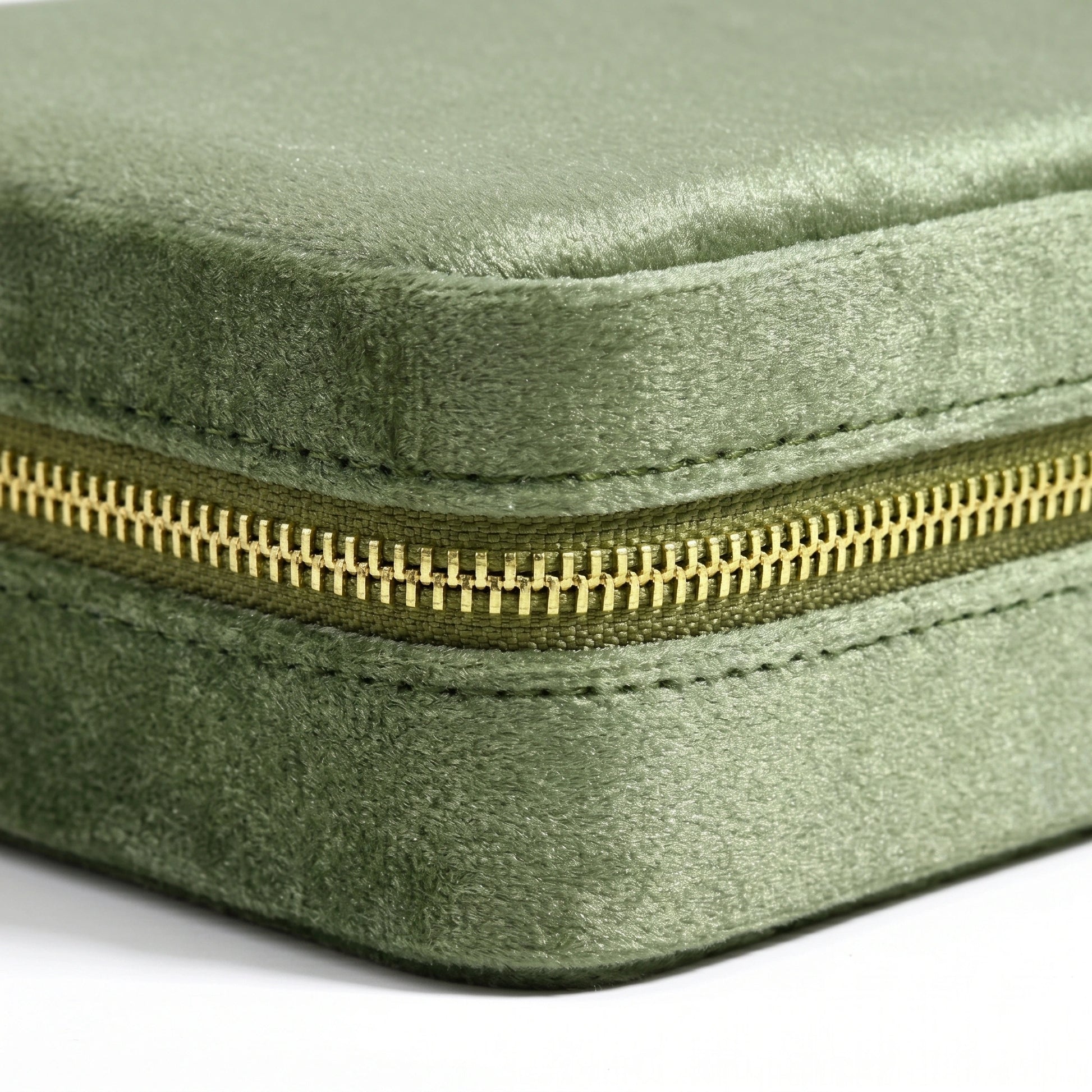 Side view of olive green velvet travel jewelry box with smooth copper zipper detail - Sensitive Stones