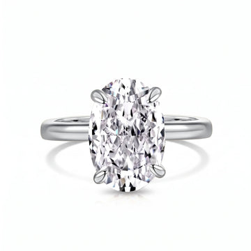 Oval cut moissanite solitaire ring in 925 sterling silver with a white gold finish on a white background showing the four prong setting - Sensitive Stones