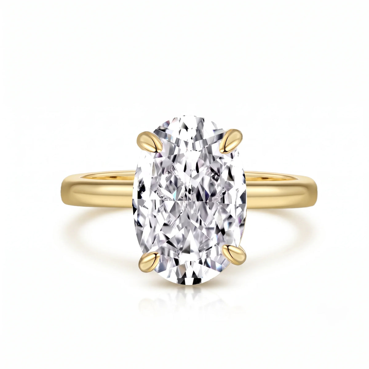 Oval cut moissanite solitaire ring in 925 sterling silver with a yellow gold finish on a white background showing the four prong setting - Sensitive Stones
