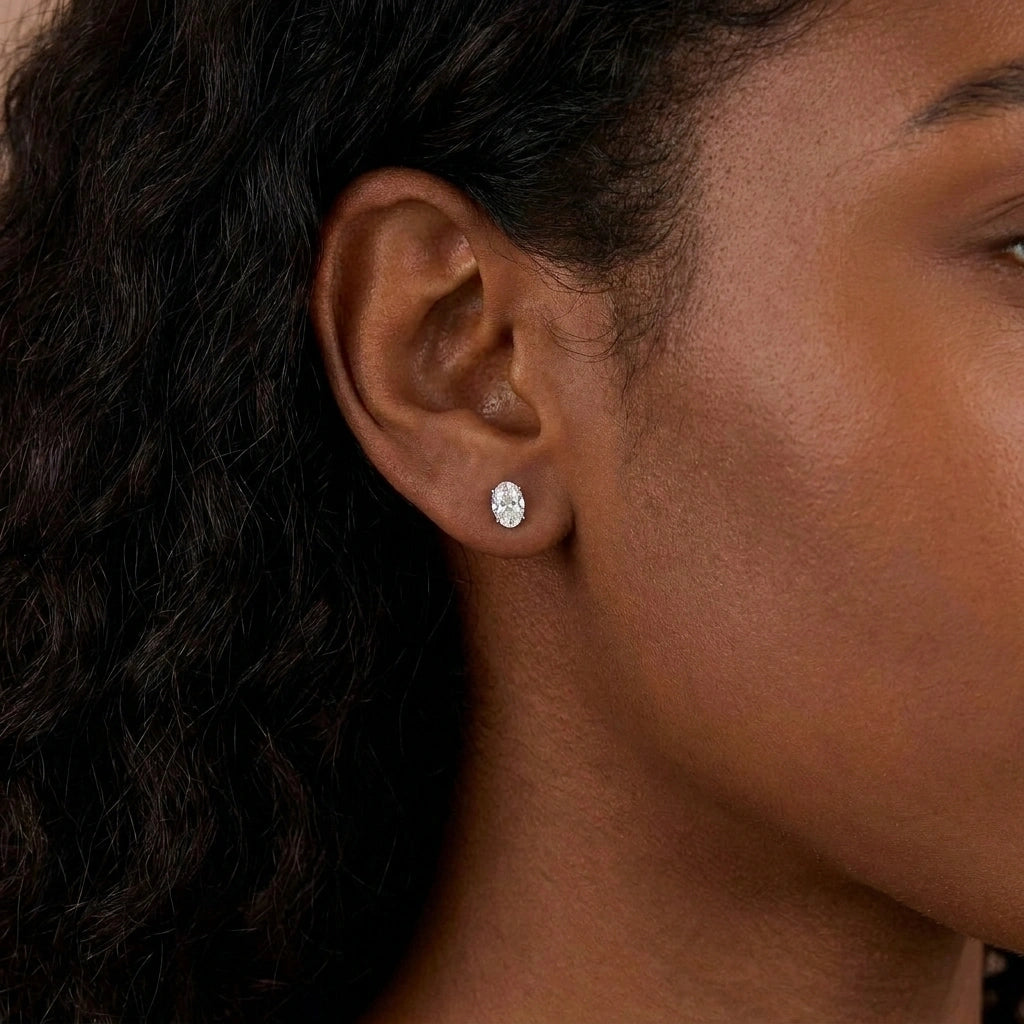 Woman wearing oval cut moissanite stud earring, 0.5ct close-up on ear - Sensitive Stones