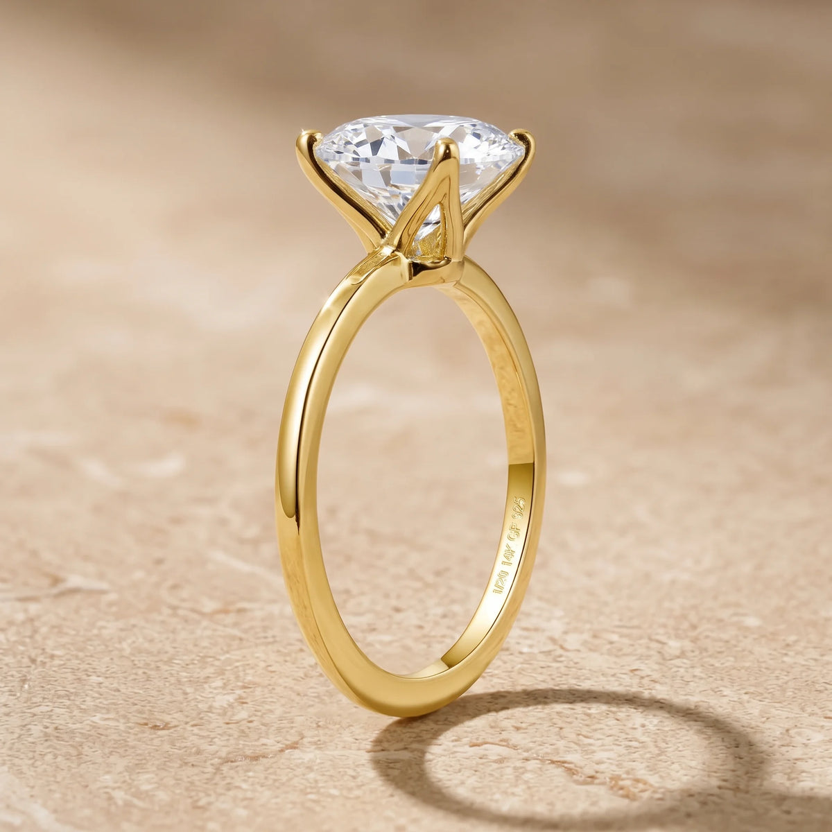 Close up of the four claw setting on an oval moissanite engagement ring in 14K gold filled