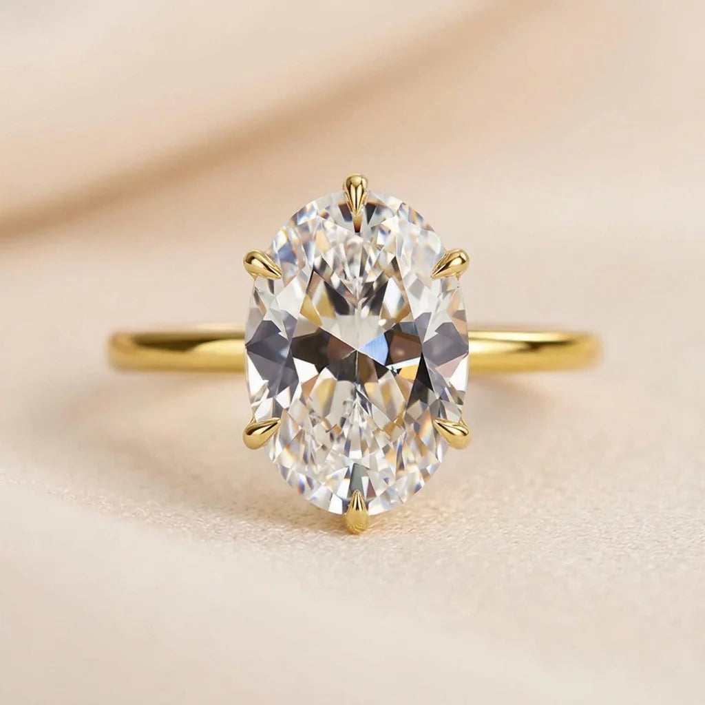 Side profile of a 14K gold filled oval moissanite engagement ring stamped 1/20 14K GF 925 inside the band