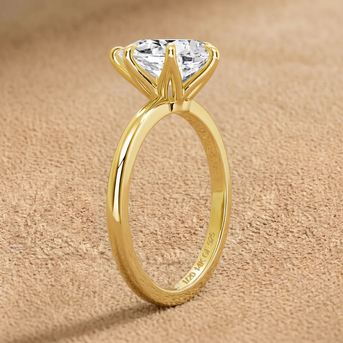 Pear cut moissanite engagement ring in 14K gold filled standing upright, showing the 1/20 14K GF 925 hallmark inside the band - Sensitive Stones