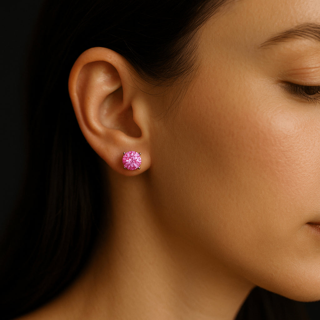 Pink moissanite stud earring worn on a woman's ear, round cut solitaire in prong setting - Sensitive Stones