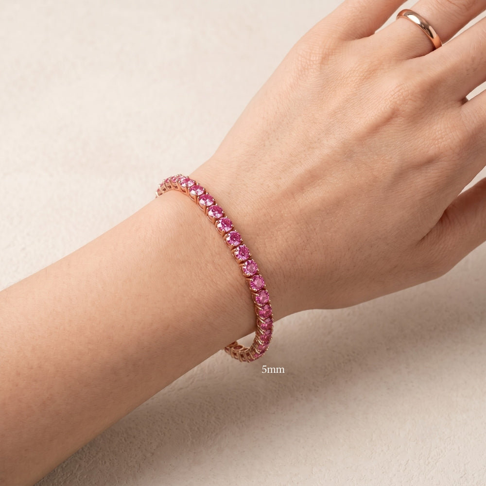 5mm pink moissanite tennis bracelet in 18K rose gold plated sterling silver worn on a woman's wrist - Sensitive Stones