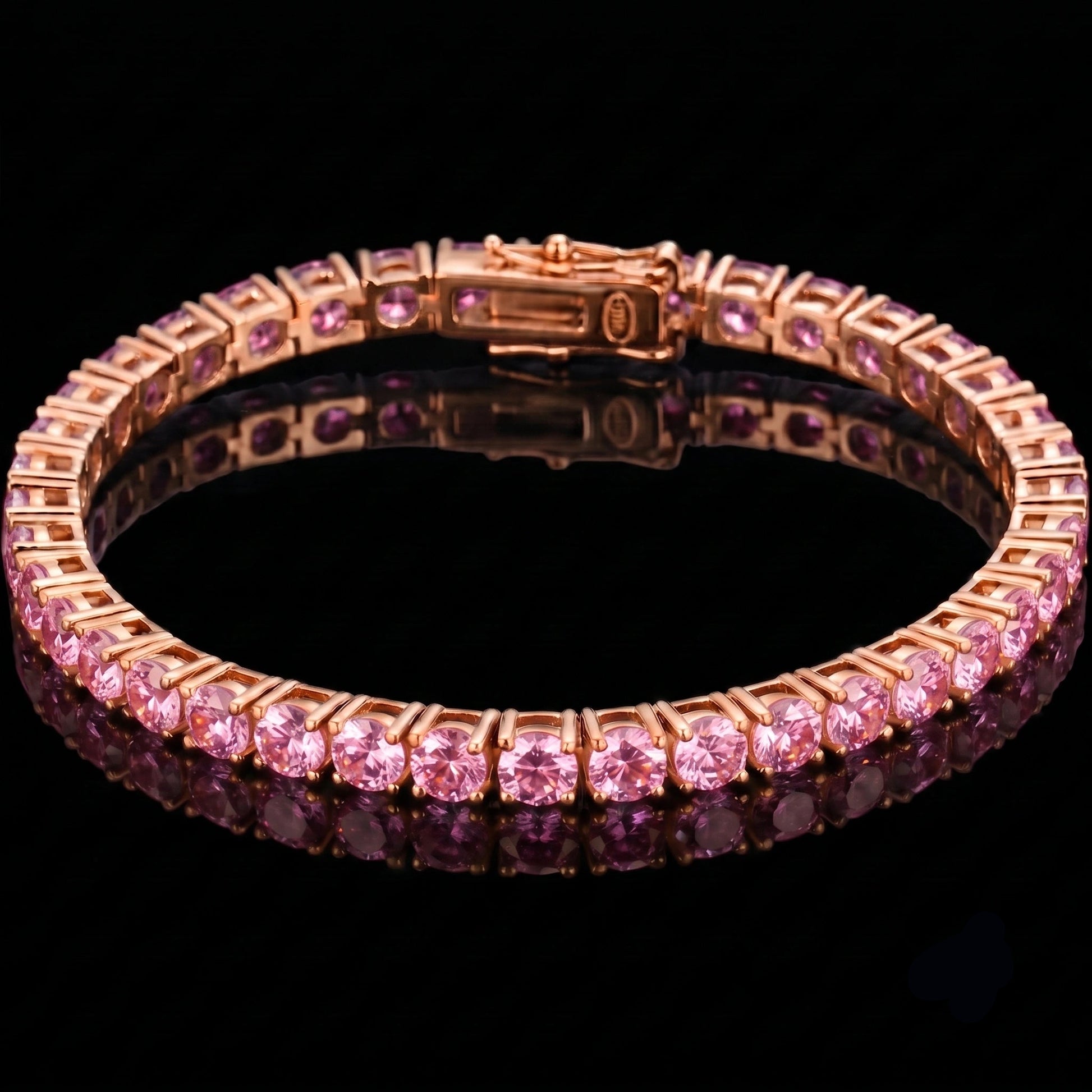 A rose gold pink moissanite tennis bracelet, displayed on a reflective black surface - Sensitive Stones