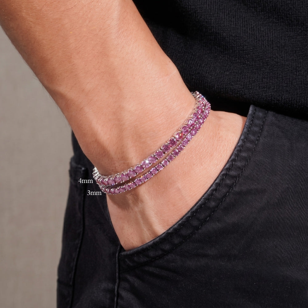 Stacked 3mm and 4mm pink moissanite tennis bracelets on a man's wrist in white gold plated sterling silver, dark outfit - Sensitive Stones