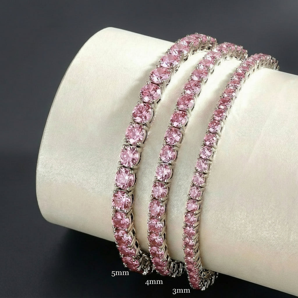 Pink Moissanite Tennis Bracelet with round-cut stones displayed on cylindrical stand showing size comparisons from 3mm, 4mm, 5mm - Sensitive Stones