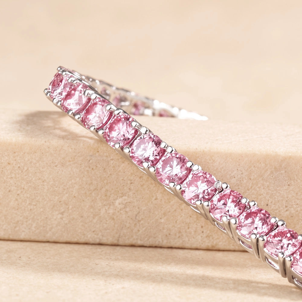 Close-up of round-cut pink moissanite tennis bracelet in white gold plated sterling silver - Sensitive Stones