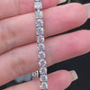 Close-up view of full moissanite tennis bracelet with VVS1 stones on sterling silver setting.