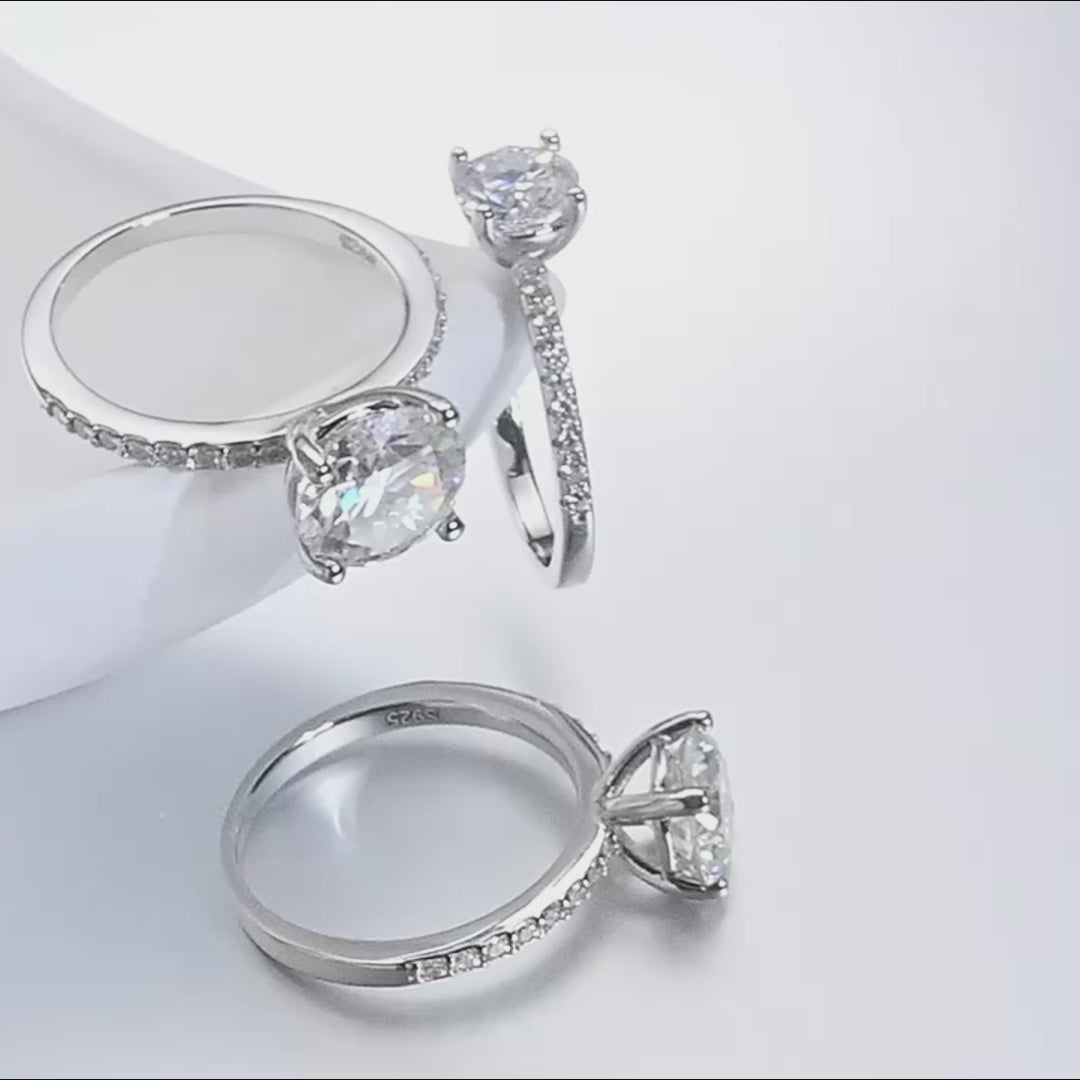 Video showing 1, 2, and 3 carat D-Color Moissanite Engagement Ring – solitaire round cut in 925 sterling silver with 18K white-gold plating, pavé CZ band, displaying exceptional sparkle and brilliance – Sensitive Stones