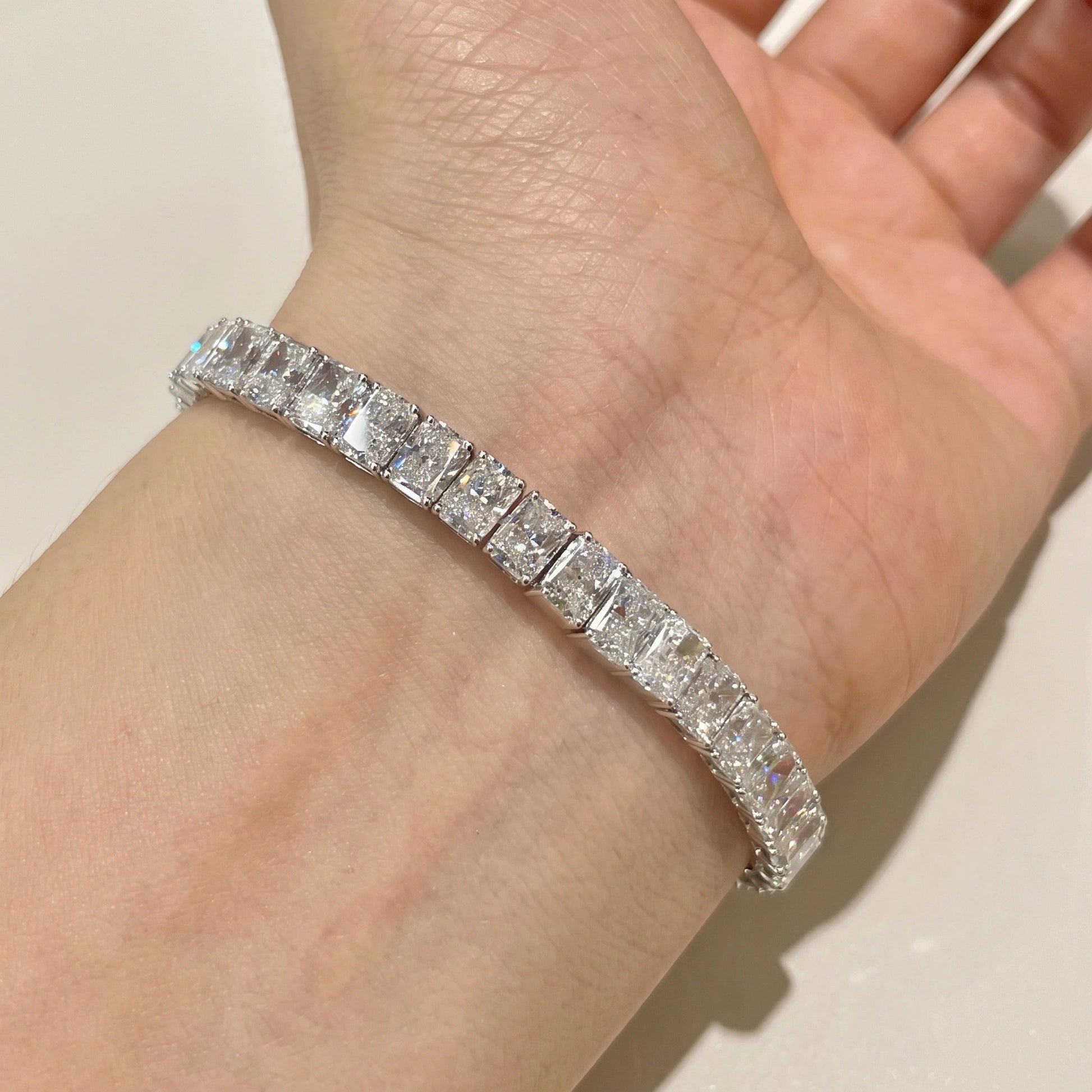 Radiant cut moissanite tennis bracelet sitting flat on the wrist for everyday wear
