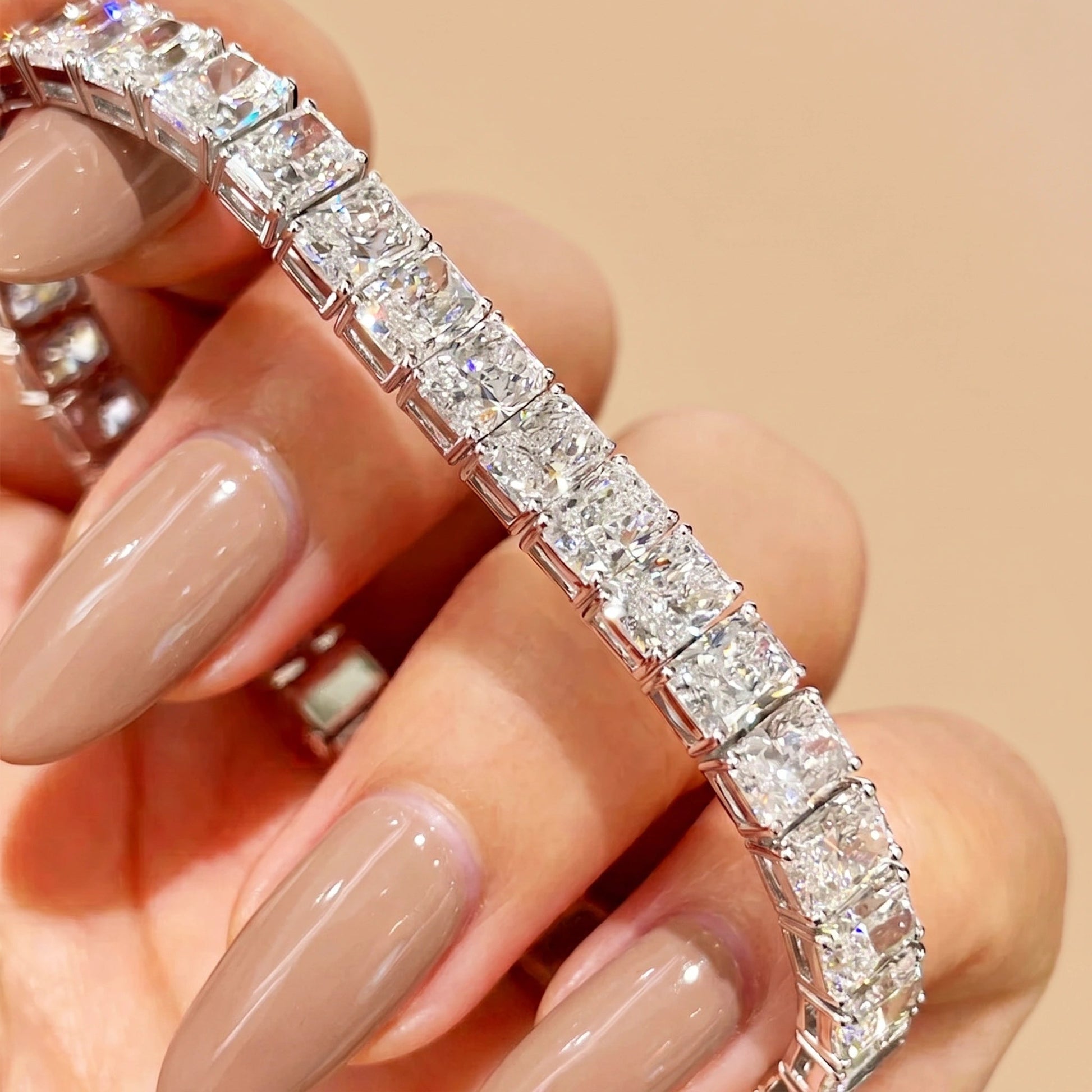Close-up of 5x3mm radiant cut moissanite stones set east-west along a sterling silver tennis bracelet