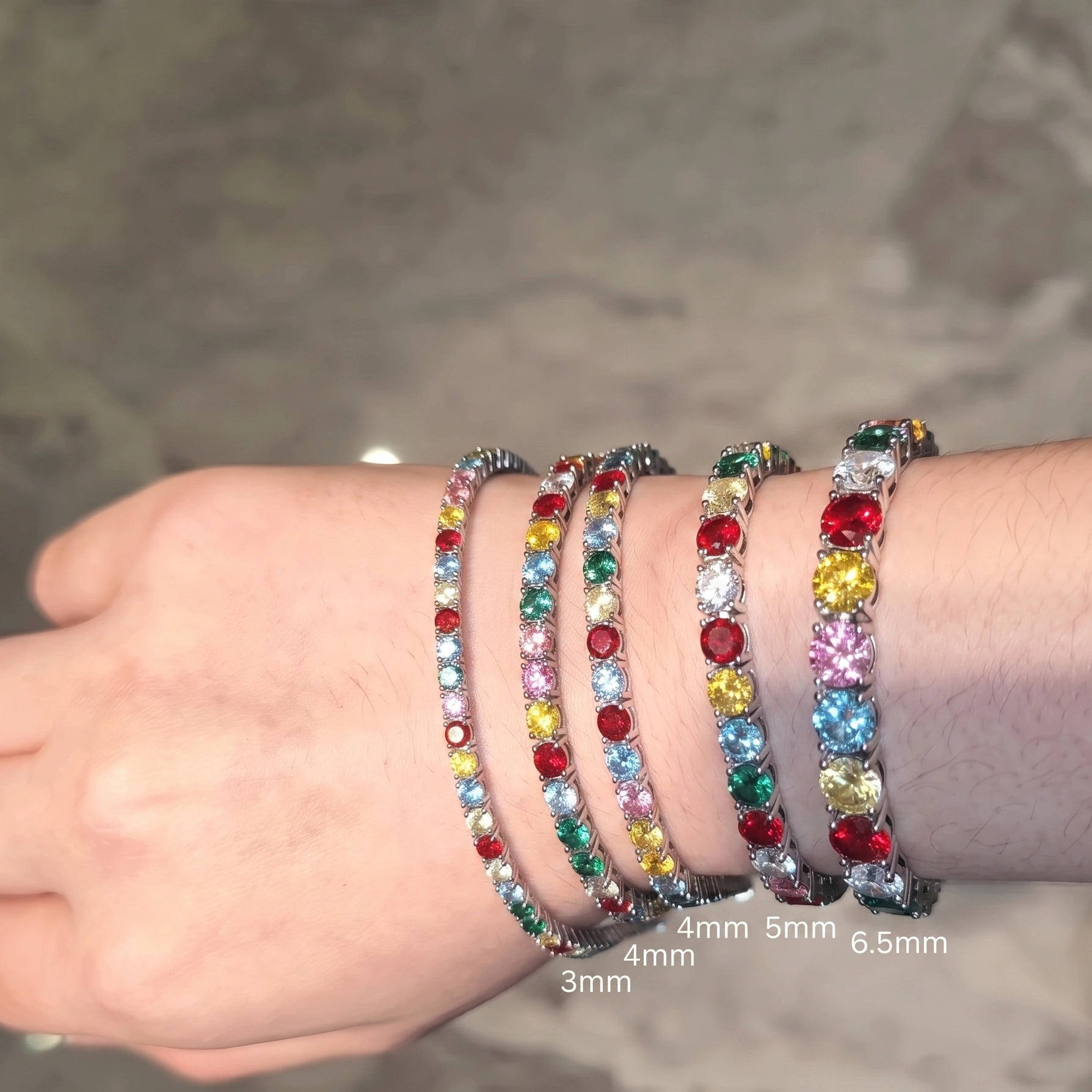 Rainbow moissanite tennis bracelet stone size comparison from 3mm to 6.5mm worn on wrist - Sensitive Stones