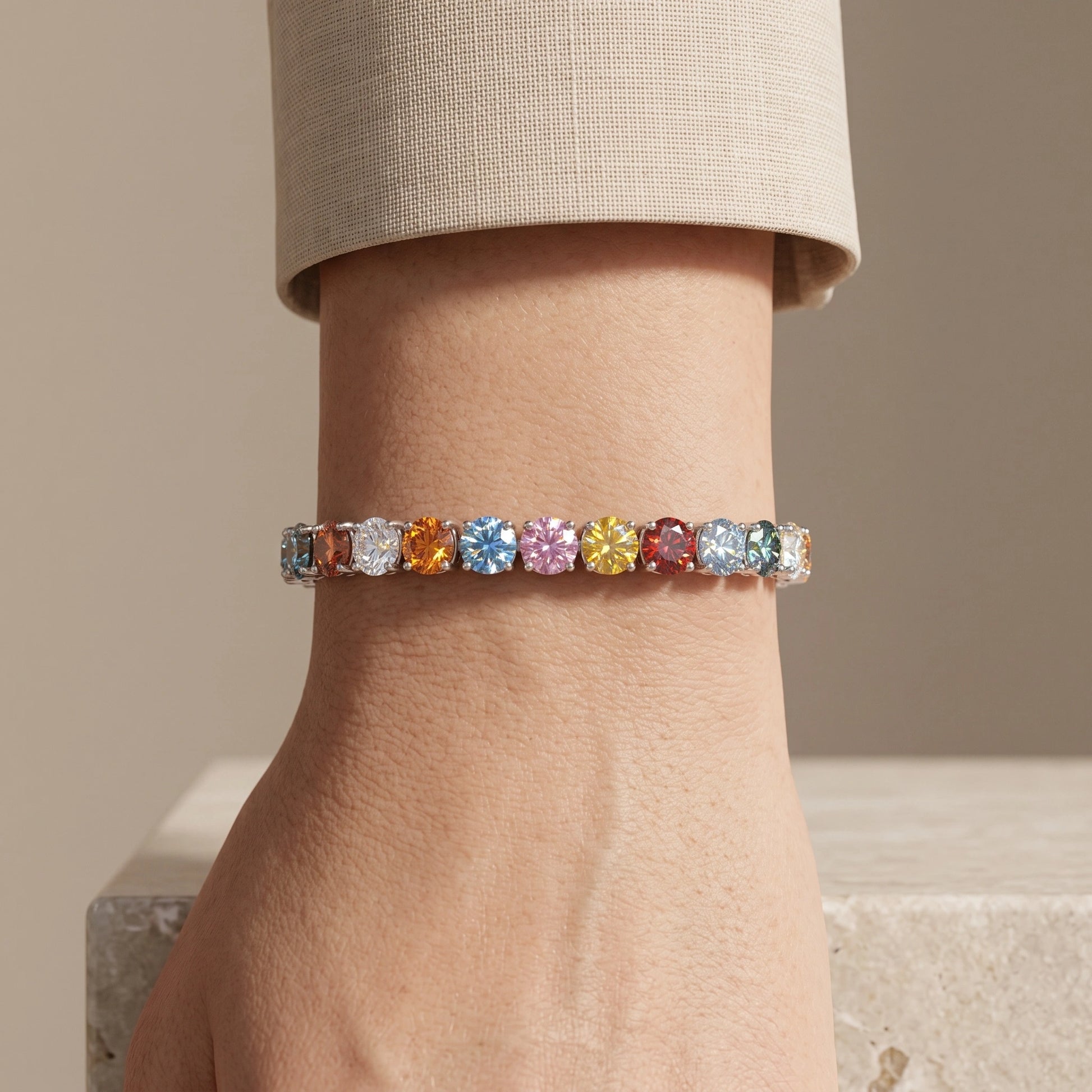 Woman wearing a rainbow moissanite tennis bracelet in 925 sterling silver - Sensitive Stones