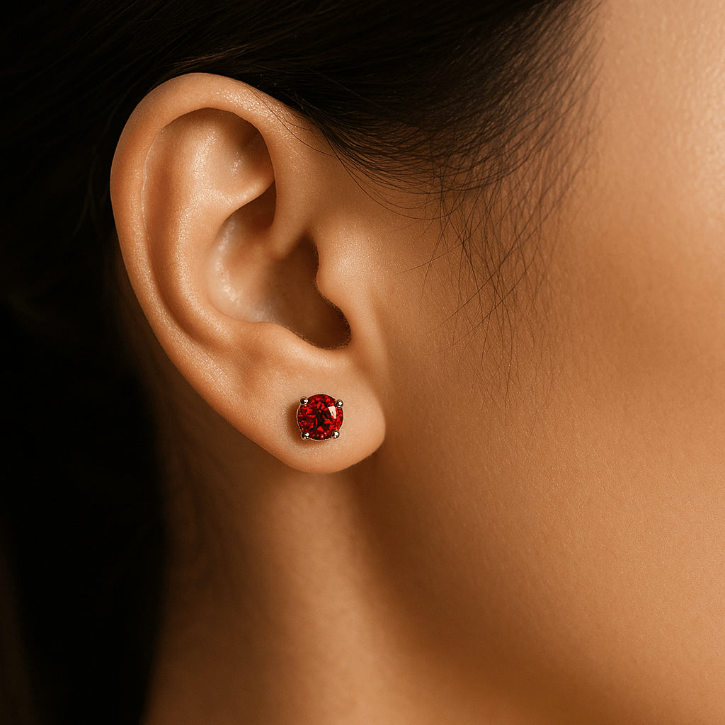 Red moissanite stud earring in a round cut worn on a woman's ear, vibrant solitaire design - Sensitive Stones