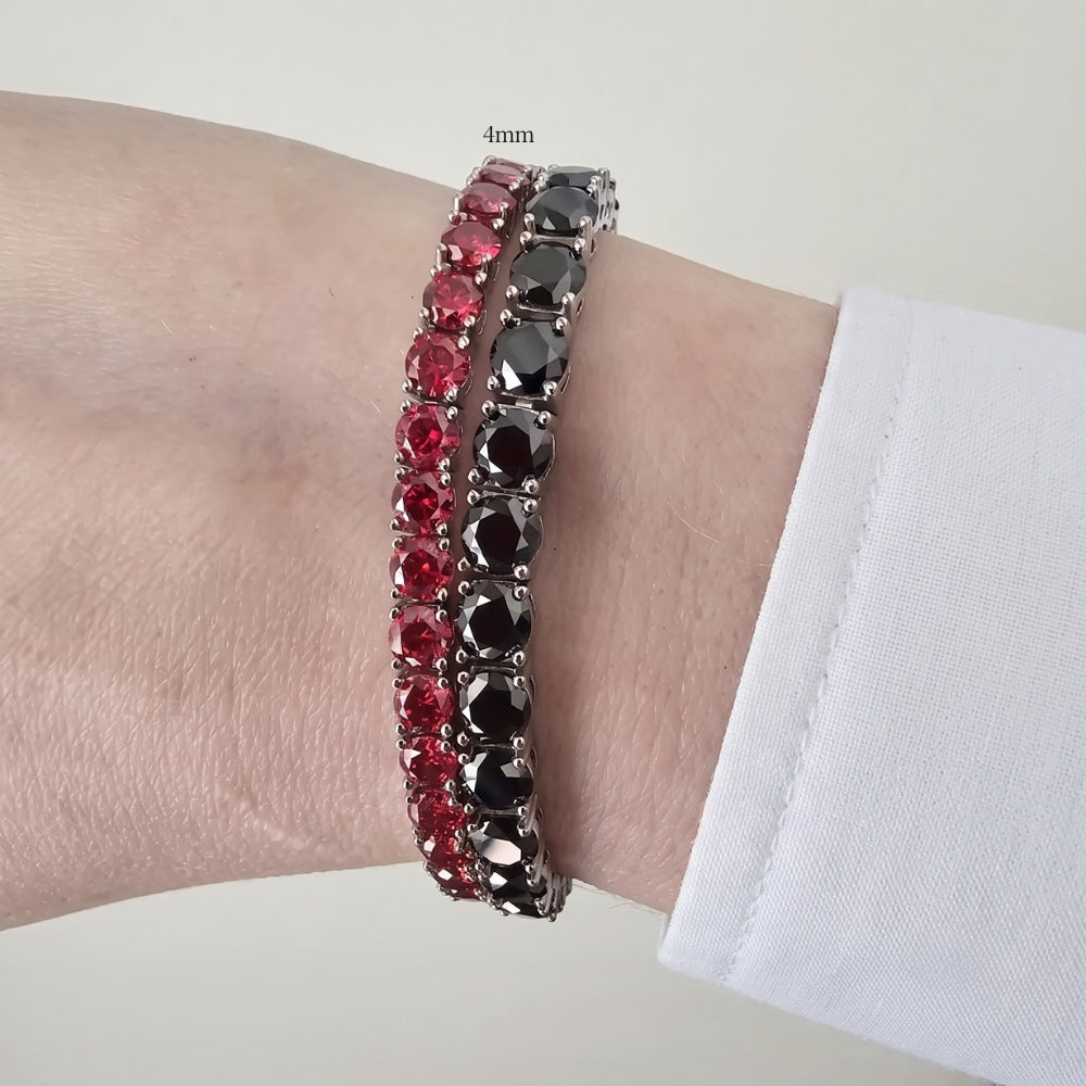 4mm red moissanite tennis bracelet in white gold plated sterling silver stacked with a black moissanite bracelet on a wrist - Sensitive Stones