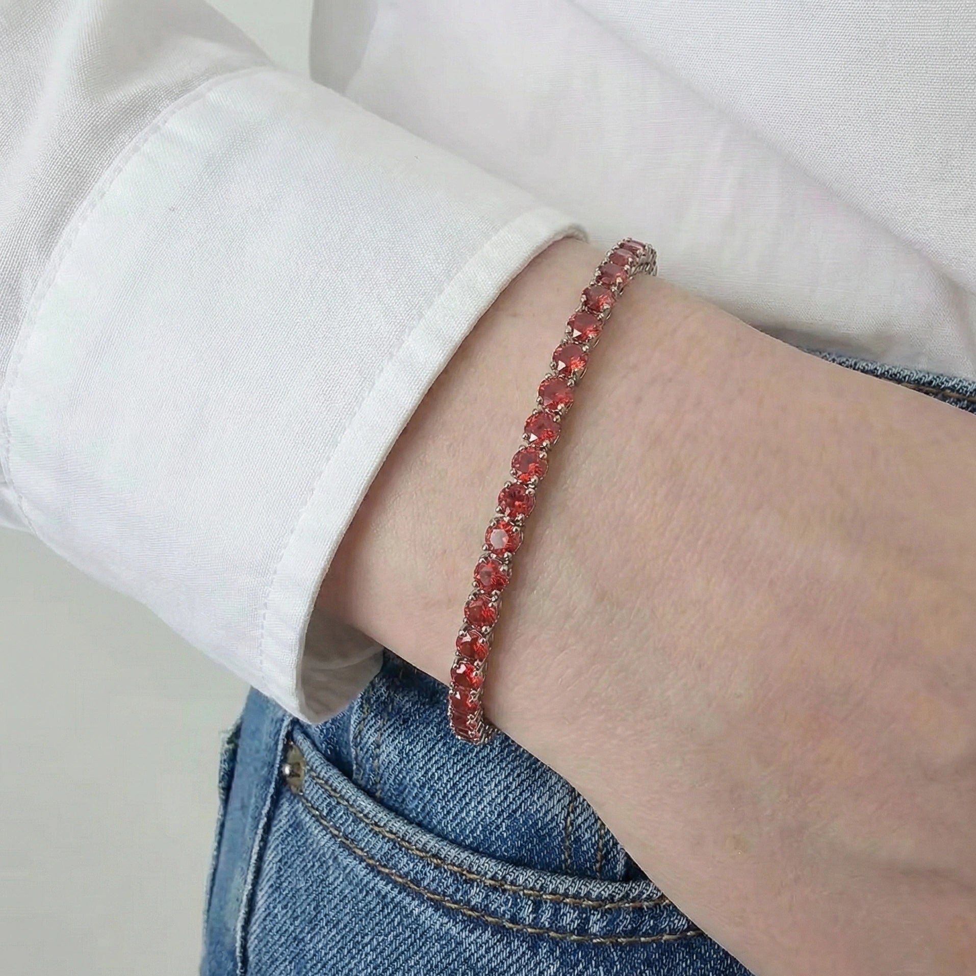 3mm Red moissanite tennis bracelet with flame-lit brilliance worn casually with white shirt and denim jeans, showcasing everyday versatile styling - Sensitive Stones