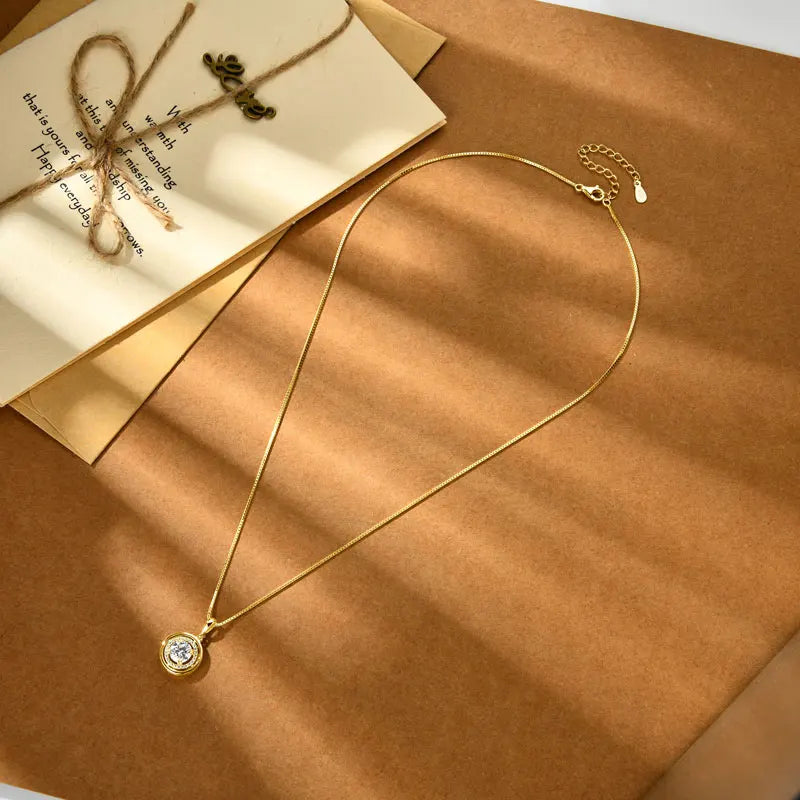 Round moissanite halo pendant necklace on a brown surface - Sensitive Stones