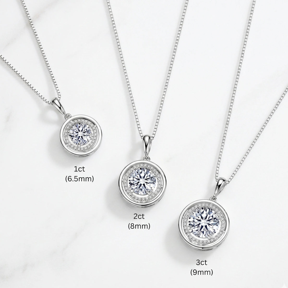 Round moissanite halo pendant necklace size comparison in a white gold finish showing 1ct 6.5mm and 2ct 8mm and 3ct 9mm center stones - Sensitive Stones