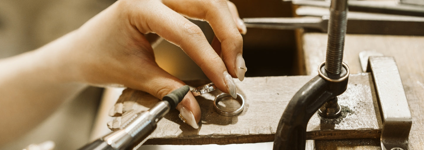 Close-up of hands polishing a silver ring – handcrafted jewelry scene for Sensitive Stones Support Hub