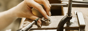 Close-up of hands polishing a silver ring – handcrafted jewelry scene for Sensitive Stones Support Hub