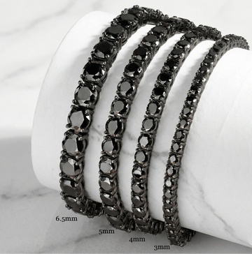Set of black moissanite tennis bracelets in black gold plating on a white stand with sizes 3mm, 4mm, 5mm, 6.5mm - Sensitive Stones