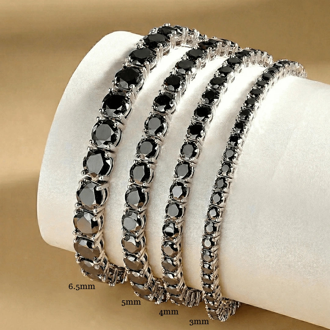 Set of black moissanite tennis bracelets in white gold plating on a white stand with sizes 3mm, 4mm, 5mm, 6.5mm - Sensitive Stones