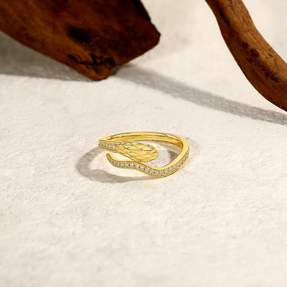 Snake Half Eternity Moissanite Ring in yellow gold displayed on textured surface - Sensitive Stones