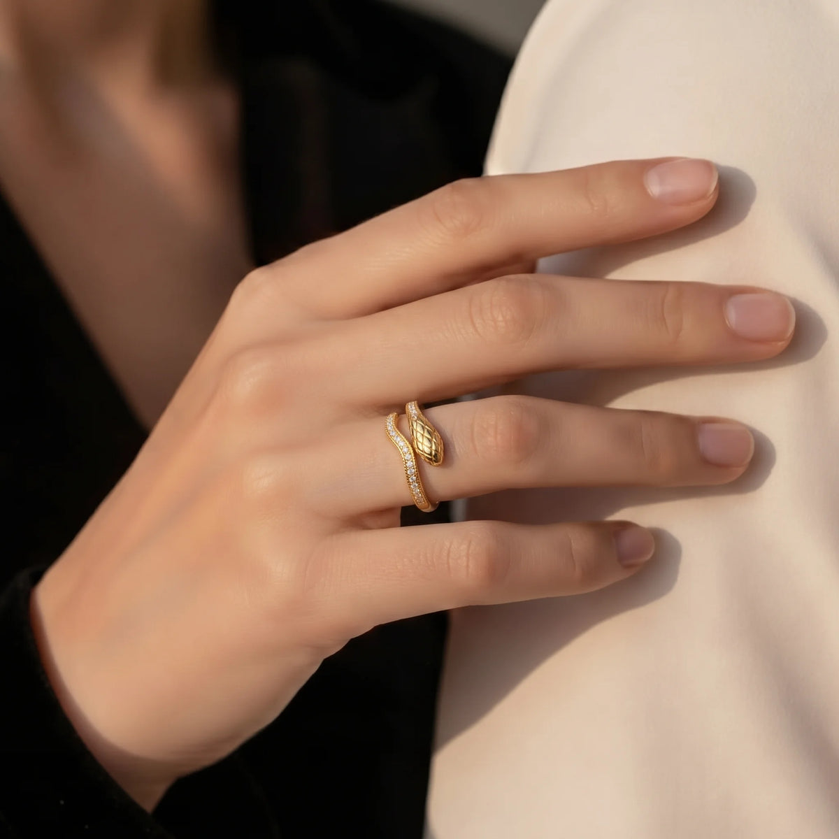 Woman wearing the snake half eternity moissanite ring in a yellow gold finish, a dainty pavé snake wrap ring, with a dark top - Sensitive Stones
