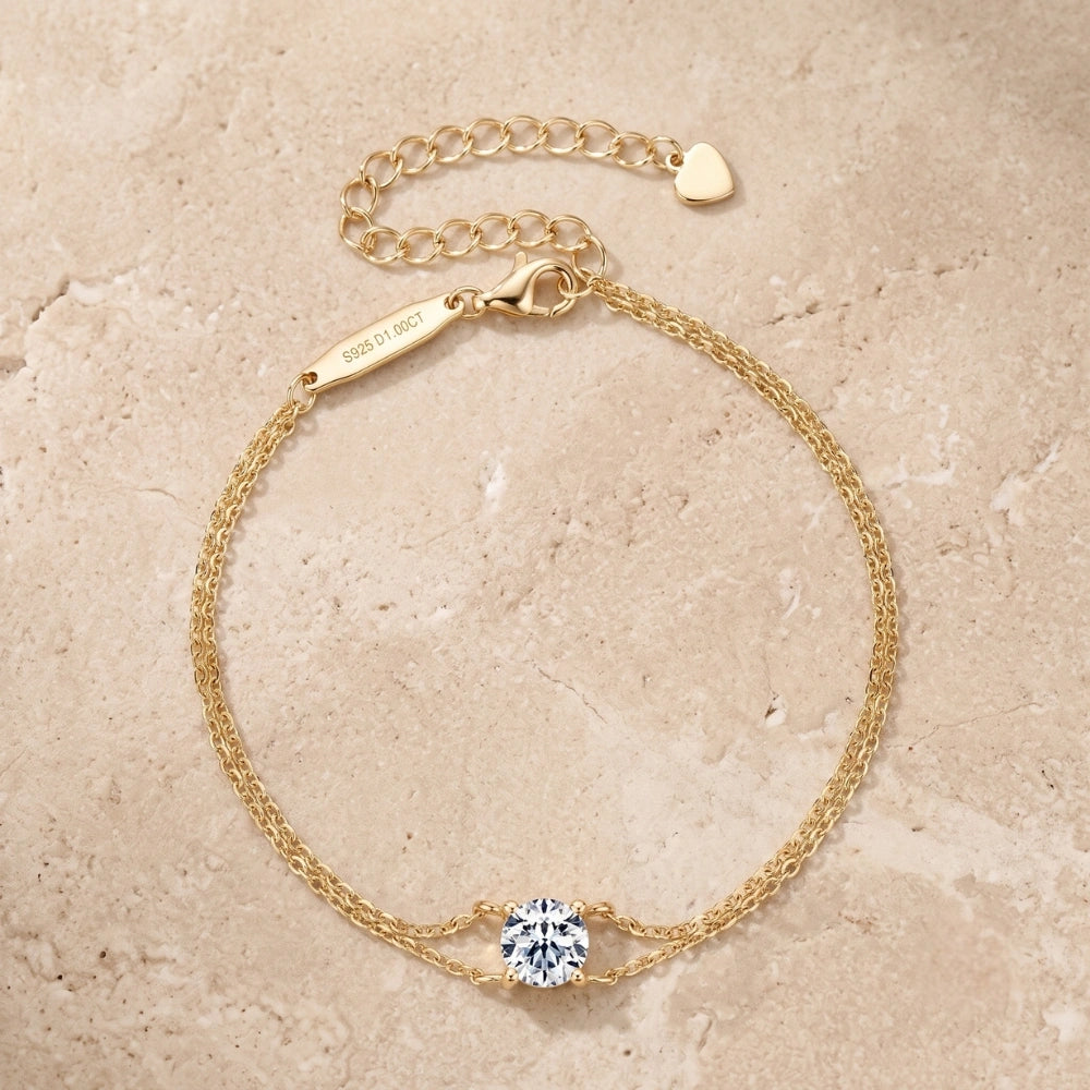 A yellow gold moissanite solitaire double chain bracelet shown flat with its lobster clasp, extender chain and round 1ct D color stone - Sensitive Stones
