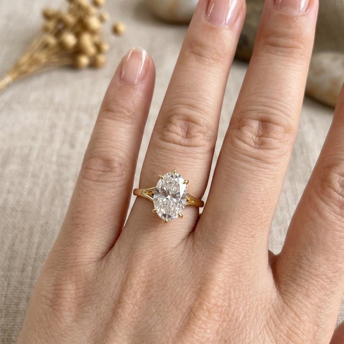 Split shank oval moissanite engagement ring in 14K gold filled worn on the hand showing the 4.5ct stone on the finger - Sensitive Stones