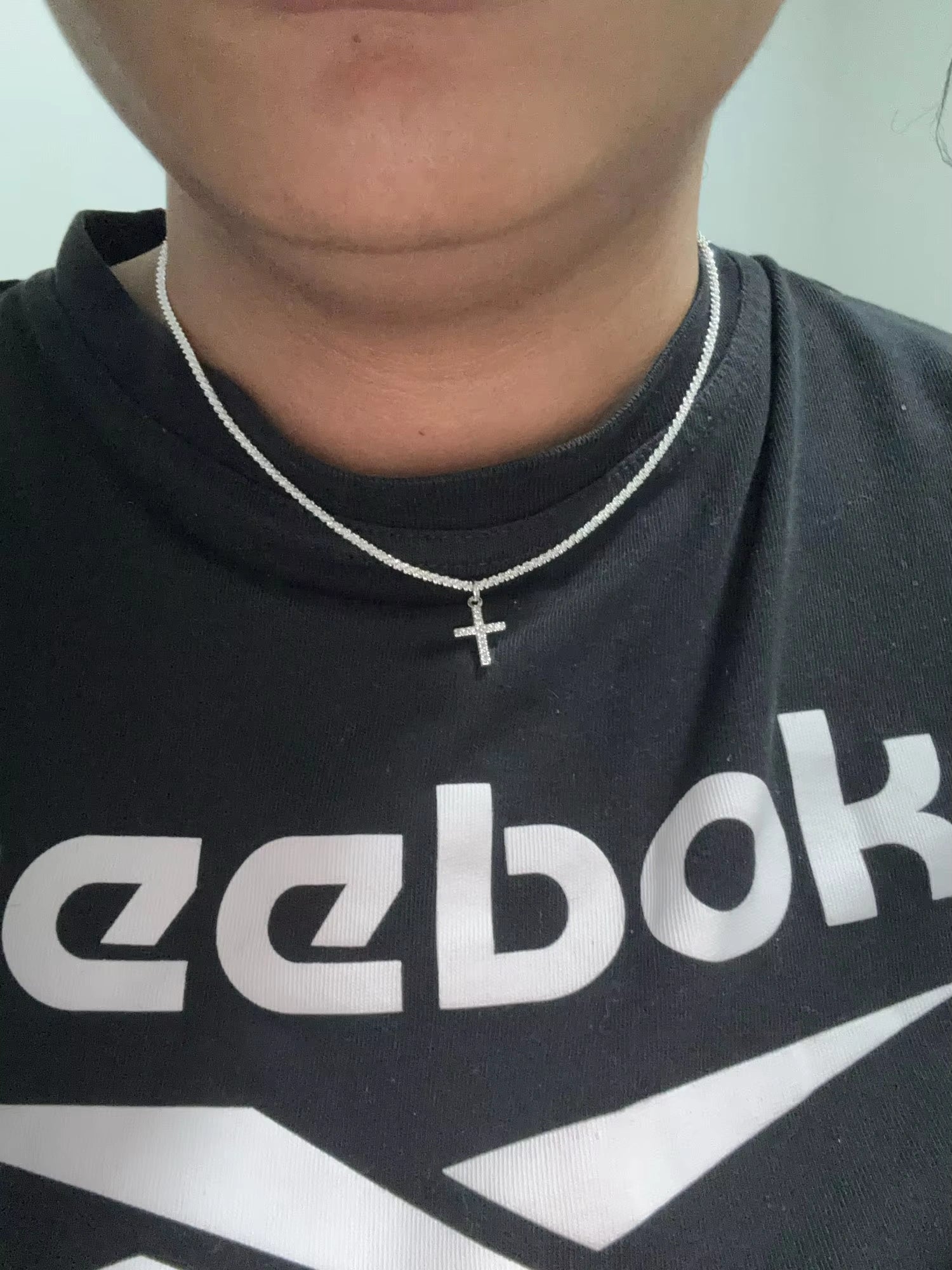 Sterling silver dainty cross necklace styled with sporty outfit