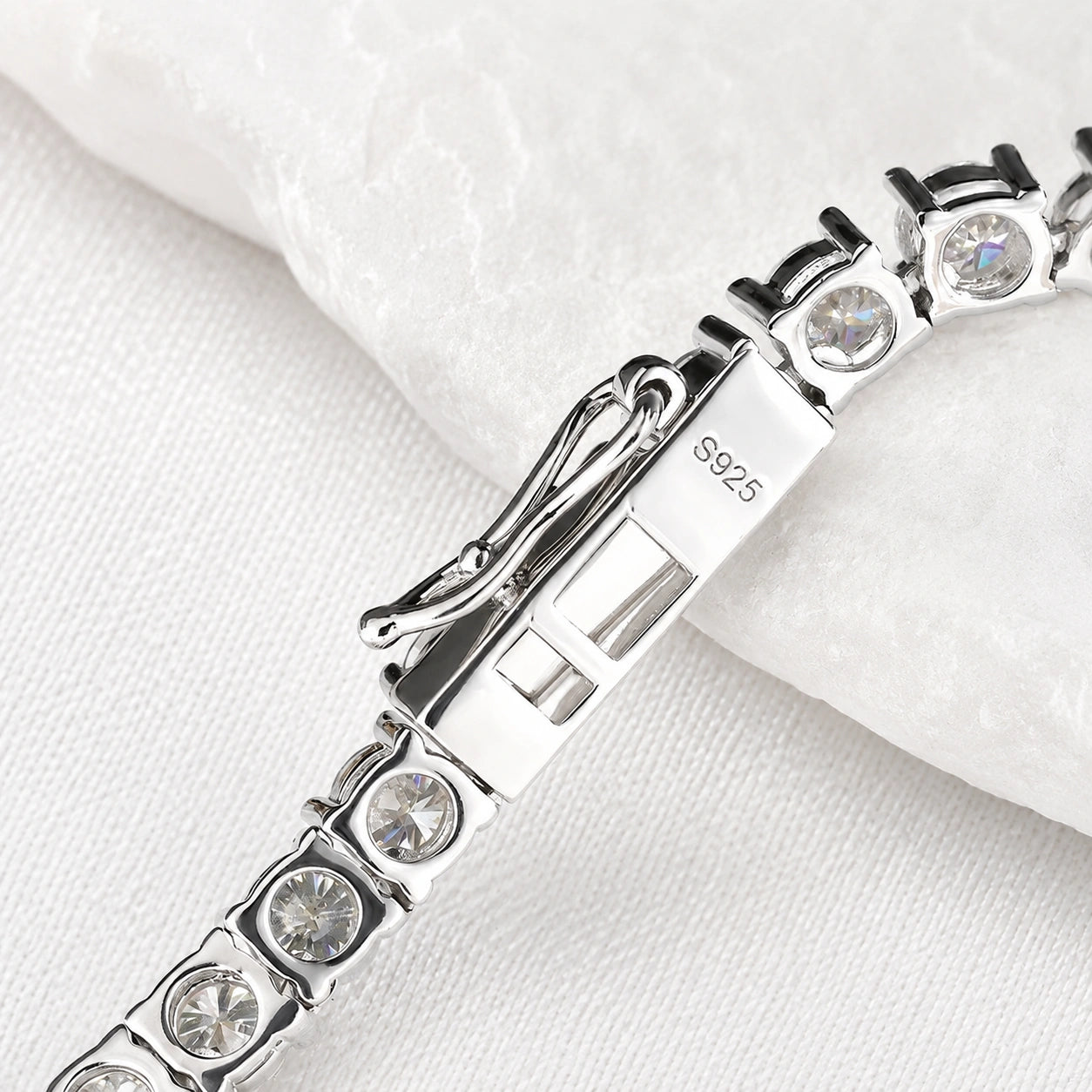 White moissanite tennis necklace clasp close-up showing S925 sterling silver hallmark, box clasp, 4-prong round stones - Sensitive Stones