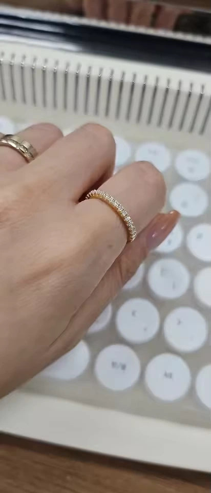 Hand wearing 18K yellow gold plated silver moissanite ring in half eternity band - Sensitive Stones
