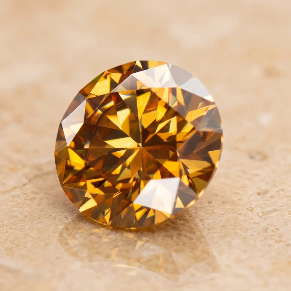 A round brilliant-cut golden yellow moissanite with rich amber and golden facets on a light beige textured surface - Sensitive Stones